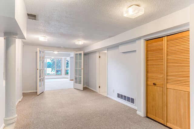 3310 Lake Johanna Blvd, Arden Hills, MN 55112 - basement with a textured ceiling, french doors, light colored carpet, and baseboards