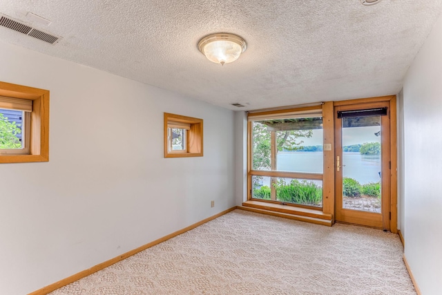 3310 Lake Johanna Blvd, Arden Hills, MN 55112 - empty room featuring light colored carpet, baseboards, and a textured ceiling