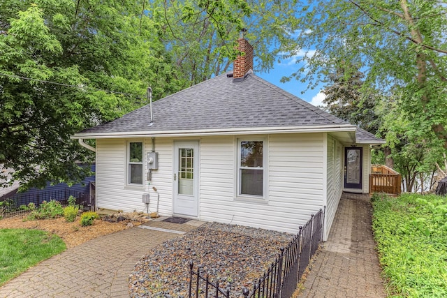 3310 Lake Johanna Blvd, Arden Hills, MN 55112 - view of front facade with a shingled roof and a chimney