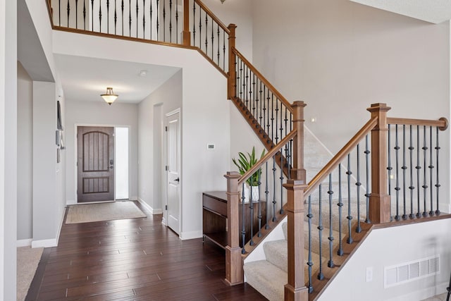 565 Juniper Ct N, Lake Elmo, MN 55042 - foyer featuring visible vents, baseboards, a high ceiling, stairs, and hardwood / wood-style flooring