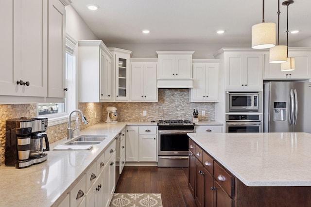 565 Juniper Ct N, Lake Elmo, MN 55042 - kitchen with white cabinets, stainless steel appliances, a sink, dark wood finished floors, and dark brown cabinets
