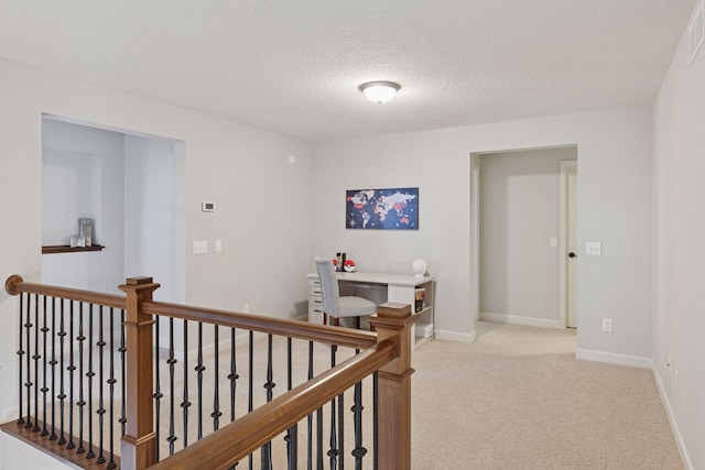 565 Juniper Ct N, Lake Elmo, MN 55042 - hallway with a textured ceiling, visible vents, baseboards, an upstairs landing, and light colored carpet