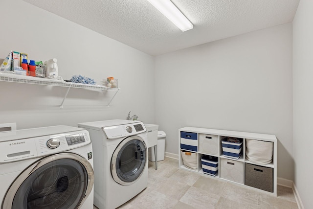 565 Juniper Ct N, Lake Elmo, MN 55042 - washroom with a textured ceiling, washer and clothes dryer, baseboards, and laundry area