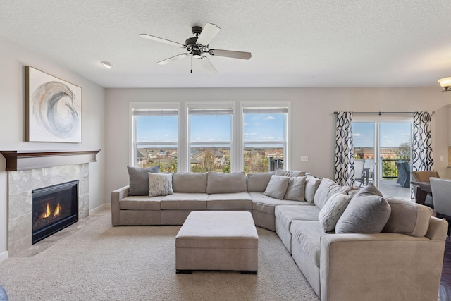 565 Juniper Ct N, Lake Elmo, MN 55042 - living room featuring a textured ceiling, a ceiling fan, carpet, and a fireplace