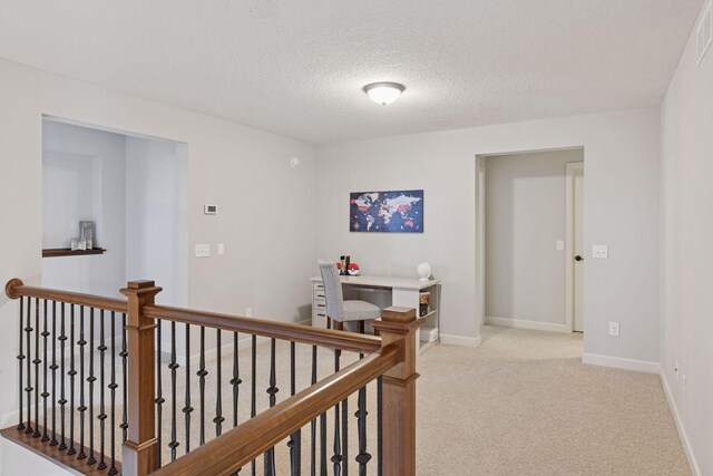 565 Juniper Ct N, Lake Elmo, MN 55042 - hallway with light colored carpet, a textured ceiling, and an upstairs landing