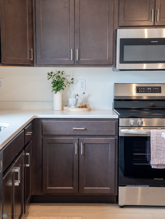 6735 Meadow View Dr S, Fargo, ND 58104 - kitchen with light countertops, appliances with stainless steel finishes, and dark brown cabinets