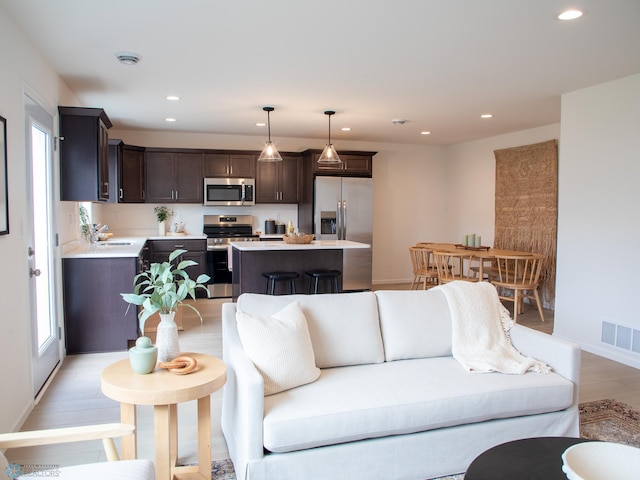 6735 Meadow View Dr S, Fargo, ND 58104 - living room featuring visible vents, recessed lighting, light wood finished floors, and baseboards