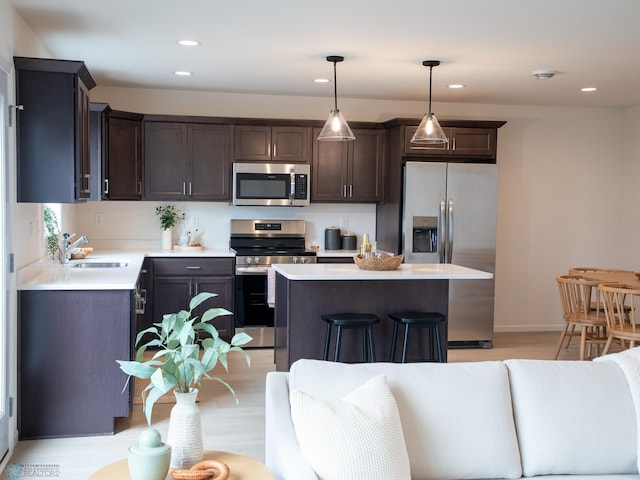 6735 Meadow View Dr S, Fargo, ND 58104 - kitchen featuring a sink, appliances with stainless steel finishes, dark brown cabinetry, and light countertops