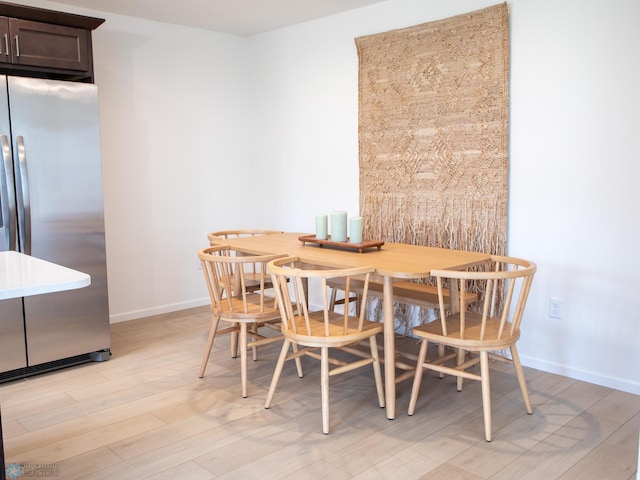 6735 Meadow View Dr S, Fargo, ND 58104 - dining area featuring baseboards and light wood-type flooring