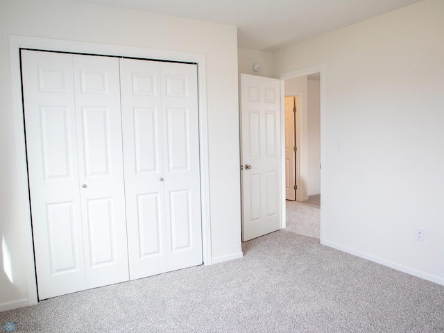 6735 Meadow View Dr S, Fargo, ND 58104 - unfurnished bedroom featuring a closet, carpet, and baseboards