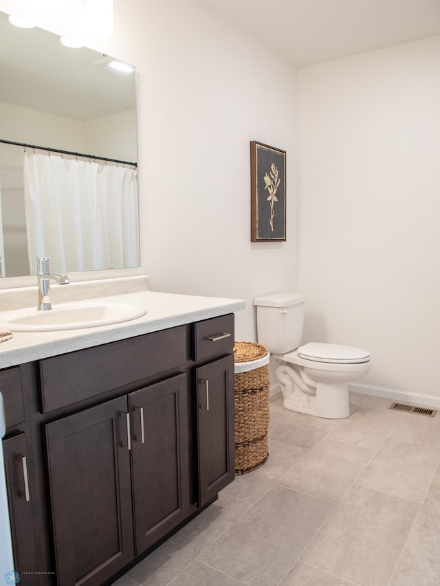 6735 Meadow View Dr S, Fargo, ND 58104 - bathroom featuring visible vents, vanity, toilet, baseboards, and tile patterned floors