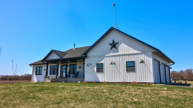 back of house featuring covered porch and a yard