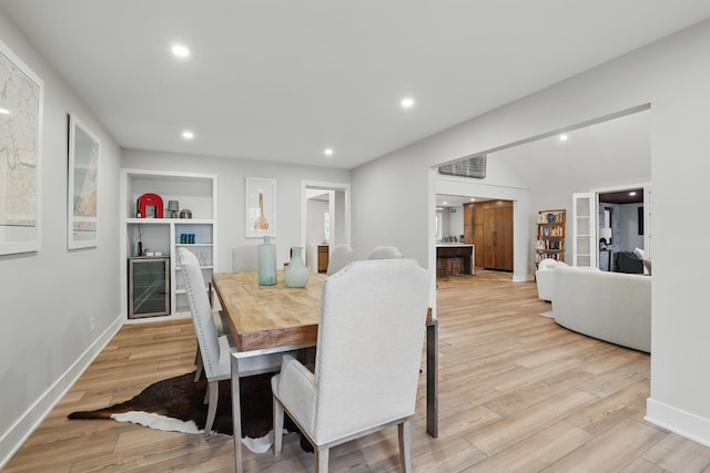 211 Peninsula Rd, Medicine Lake, MN 55441 - dining space with light wood-style flooring, wine cooler, baseboards, built in shelves, and recessed lighting