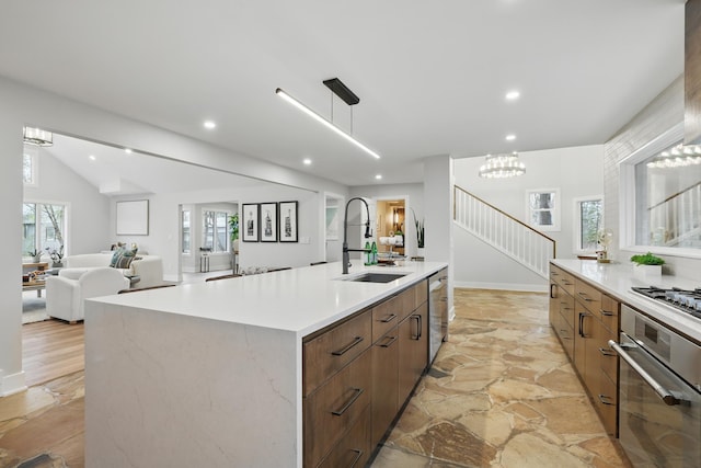 211 Peninsula Rd, Medicine Lake, MN 55441 - kitchen with stainless steel appliances, a sink, modern cabinets, stone flooring, and light countertops