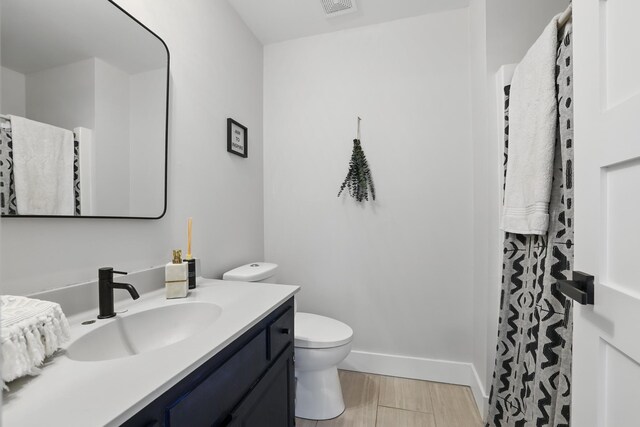 211 Peninsula Rd, Medicine Lake, MN 55441 - full bathroom featuring vanity, toilet, wood finished floors, a shower with curtain, and baseboards
