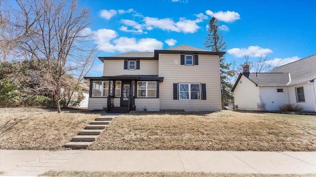 traditional-style home with a front lawn