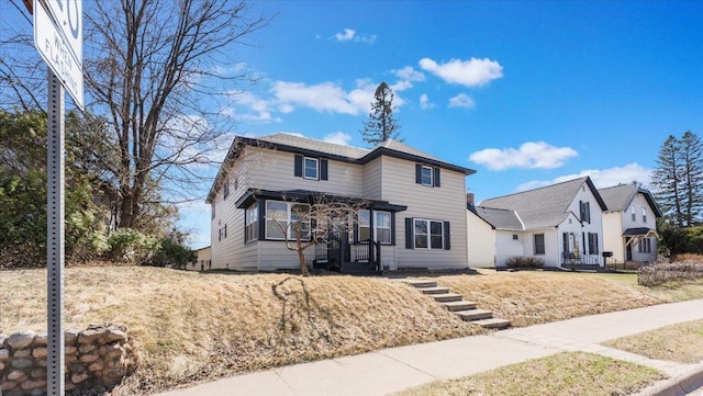 traditional-style home featuring a front yard