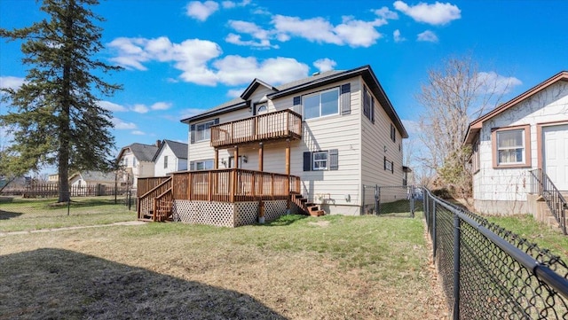 rear view of property featuring a fenced backyard, stairway, a deck, and a lawn