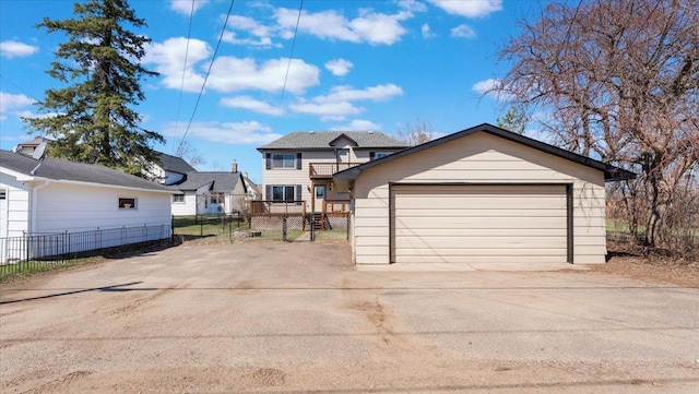 view of front of property with fence and a garage