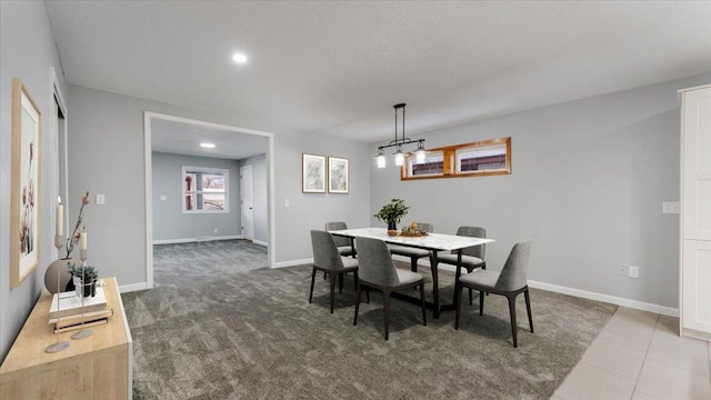 carpeted dining space with baseboards, a textured ceiling, and recessed lighting