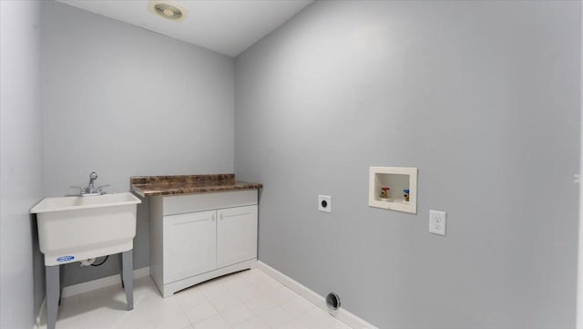 washroom featuring cabinet space, washer hookup, baseboards, and hookup for an electric dryer