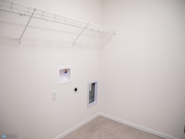 washroom with laundry area, light tile patterned flooring, baseboards, washer hookup, and hookup for an electric dryer