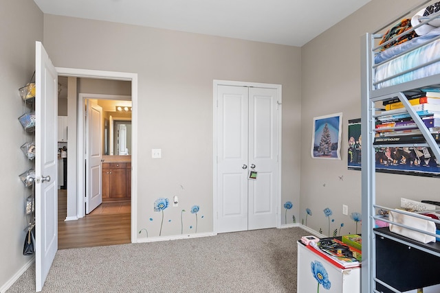 rec room featuring carpet flooring and baseboards
