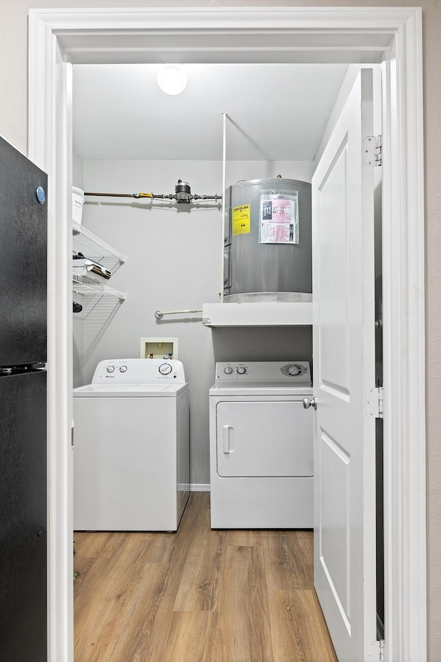washroom featuring laundry area, independent washer and dryer, and wood finished floors