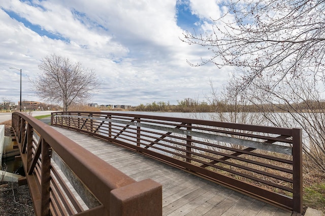 wooden terrace featuring a water view