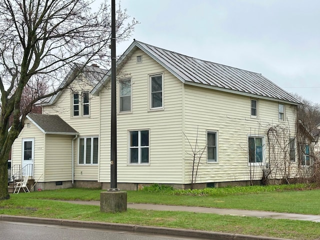126 Columbia St, Chippewa Falls, WI 54729 - view of property exterior with a lawn and metal roof