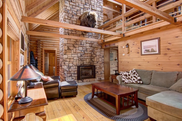 E6516 867th Ave, Colfax, WI 54730 - living area with hardwood / wood-style floors, beam ceiling, a towering ceiling, a fireplace, and log walls
