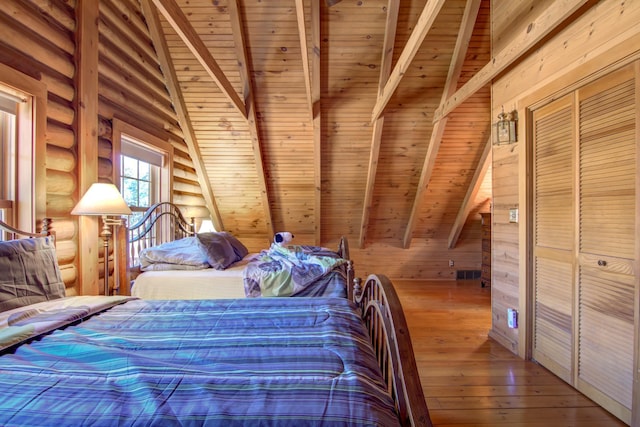 E6516 867th Ave, Colfax, WI 54730 - bedroom with wooden ceiling, hardwood / wood-style flooring, and rustic walls