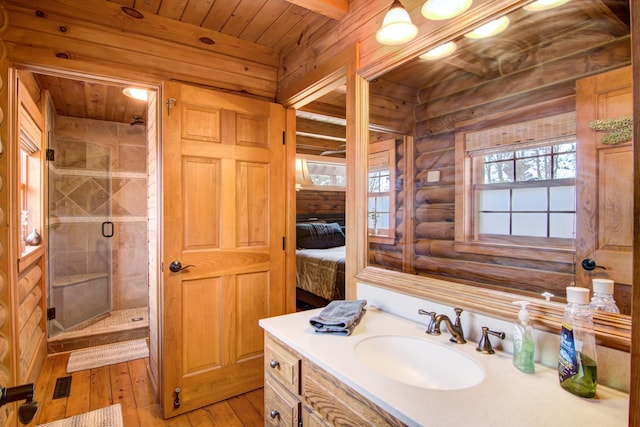 E6516 867th Ave, Colfax, WI 54730 - full bath featuring log walls, wood-type flooring, a shower stall, wood ceiling, and vanity