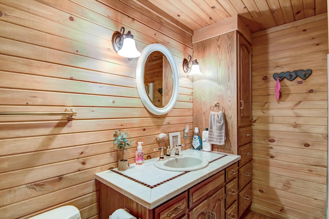 E6516 867th Ave, Colfax, WI 54730 - bathroom featuring wooden walls, vanity, toilet, and wooden ceiling