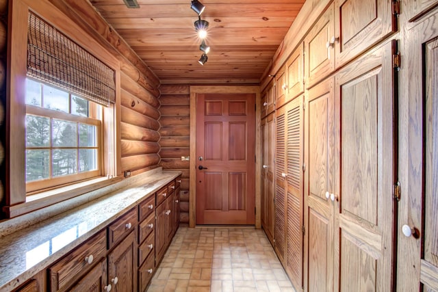 E6516 867th Ave, Colfax, WI 54730 - doorway featuring log walls, wooden ceiling, and brick patterned flooring