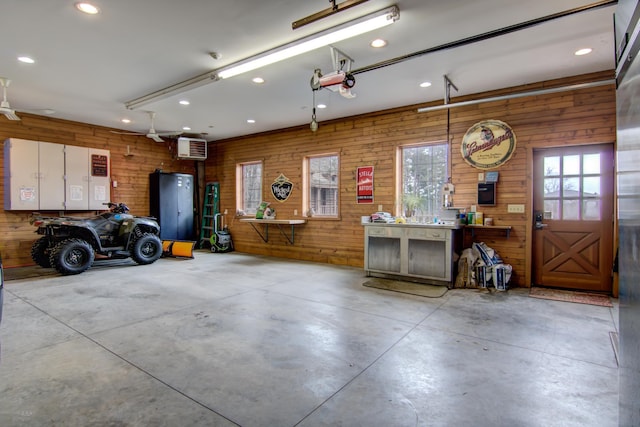 E6516 867th Ave, Colfax, WI 54730 - garage with recessed lighting, wood walls, and a workshop area
