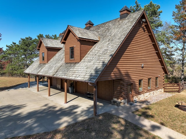 E6516 867th Ave, Colfax, WI 54730 - view of side of home featuring driveway, a garage, and a yard