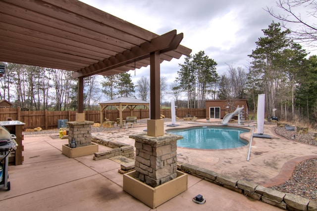 E6516 867th Ave, Colfax, WI 54730 - view of pool featuring a water slide, a patio area, an outbuilding, and a fenced backyard
