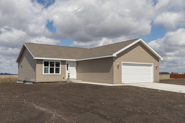 214 4th Pl, Claremont, MN 55924 - single story home featuring an attached garage, driveway, and a shingled roof