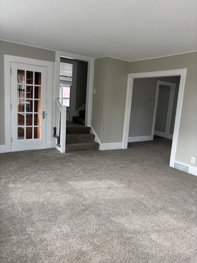 718 4th St N, Stillwater, MN 55082 - carpeted empty room with a textured ceiling, stairs, and visible vents