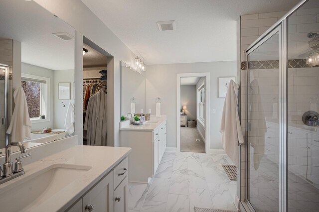 12816 Cedar Ridge Ln, Champlin, MN 55316 - full bathroom with marble finish floors, two vanities, a shower stall, and a spacious closet