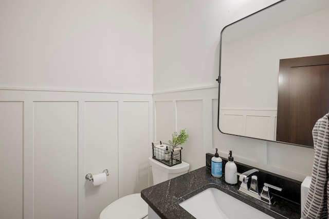12816 Cedar Ridge Ln, Champlin, MN 55316 - bathroom featuring a decorative wall, vanity, and a wainscoted wall