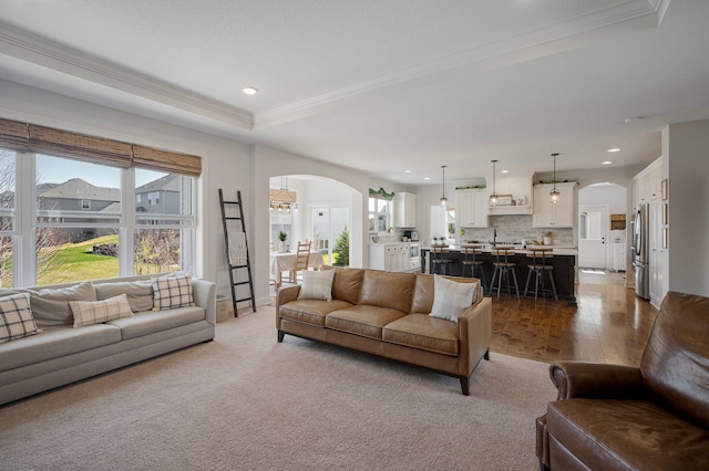 12816 Cedar Ridge Ln, Champlin, MN 55316 - living room featuring arched walkways, recessed lighting, crown molding, and dark wood-type flooring