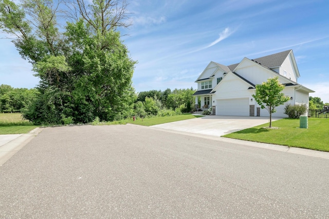12816 Cedar Ridge Ln, Champlin, MN 55316 - view of front facade featuring a front yard, driveway, and an attached garage