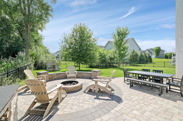 12816 Cedar Ridge Ln, Champlin, MN 55316 - fenced backyard with a fire pit, a patio, outdoor dining area, and a playground