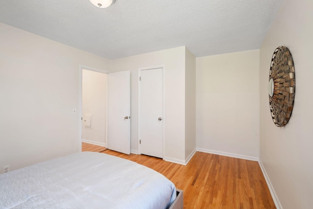 bedroom with baseboards and light wood-type flooring