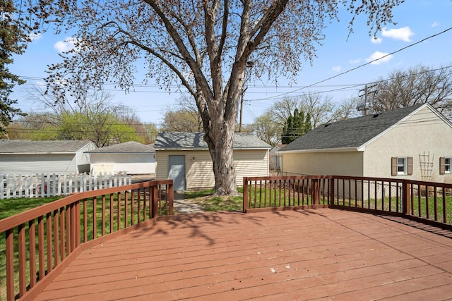deck featuring fence and an outbuilding
