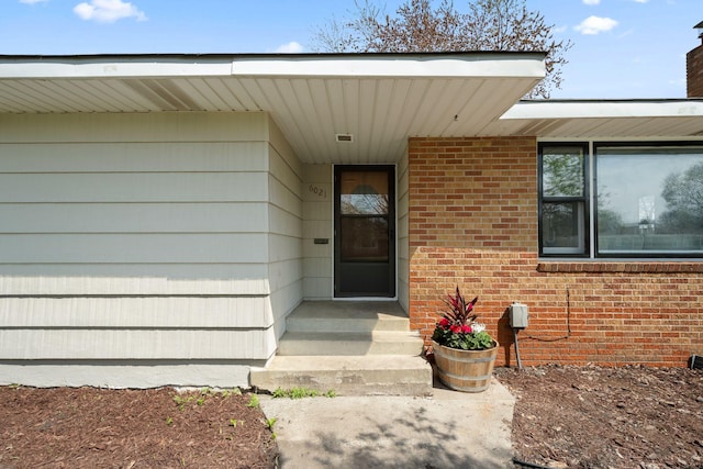 entrance to property with brick siding