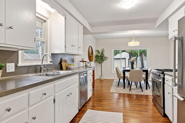 4024 Quentin Ave, Saint Louis Park, MN 55416 - kitchen featuring stainless steel appliances, white cabinets, dark wood-type flooring, and tasteful backsplash