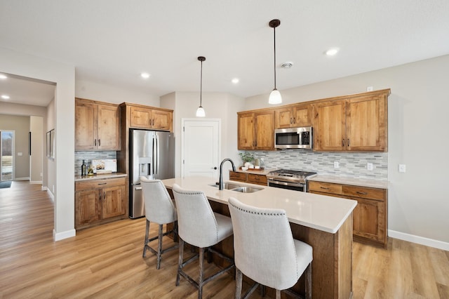19999 Hunters Rdg, Corcoran, MN 55374 - kitchen with appliances with stainless steel finishes, a sink, backsplash, brown cabinets, and recessed lighting